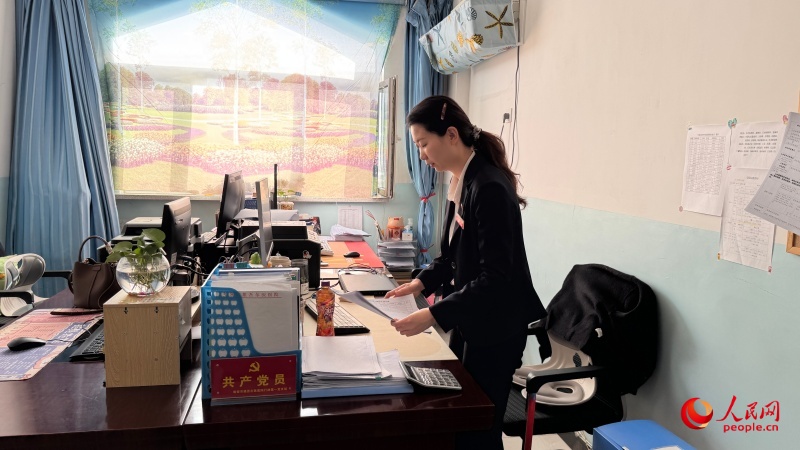 王梦莹一边翻看记录，一边介绍。人民网 娜地拉摄